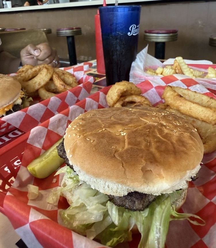 Garlic Cheese Steer burger with onion rings, served at the counter