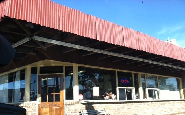 Roshell's brick storefront with a red metal awning and wide picture windows